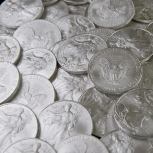 a bunch of silver coins spread out